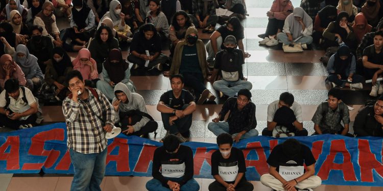Kerumunan massa demonstrasi duduk menanti pertemuan dengan Rektor Unhas di Depan Rektorat, Senin (03/04). Sumber: IDENTITAS/Agif