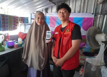 Foto bersama Mahasiswa KKNT Unhas dengan salah satu pedagang di Kelurahan Pangkajene, Kabupaten Sidrap dalam sosialisasi pembayaran QRIS, Selasa (26/7). Foto: Dokumentasi Pribadi